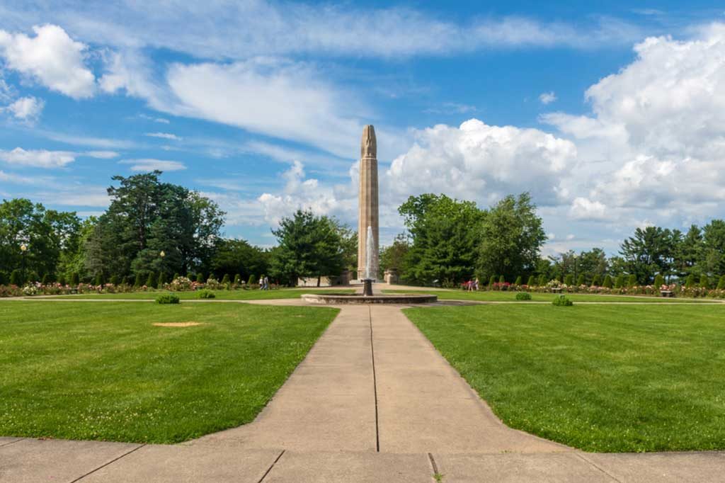 New Britain, Connecticut / USA - June 30 2019: A path leads to a fountain and the World War 1 memorial in the Walnut Hill Park rose garden in New Britain, Connecticut